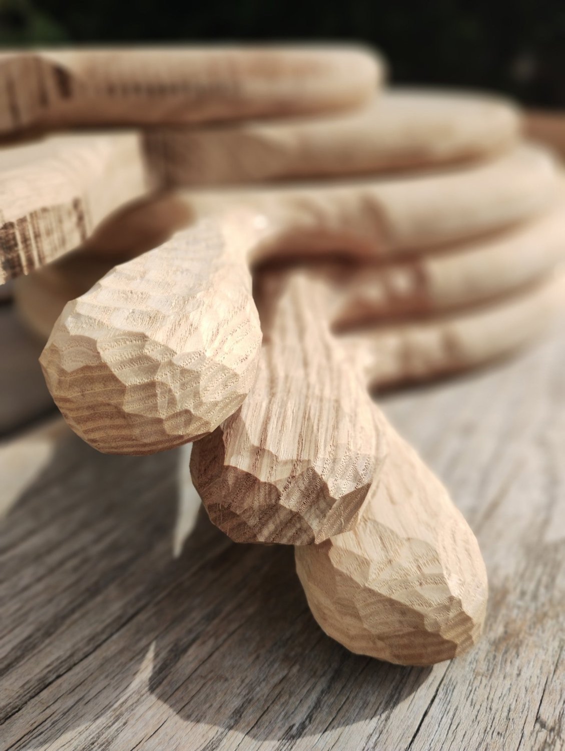 Close view of carved wooden pizza board handle and grain texture