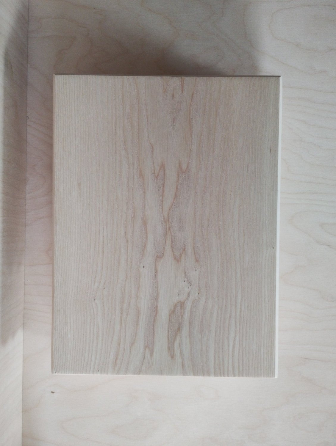 Rectangular ash chopping board showing pale wood grain and minimal markings.