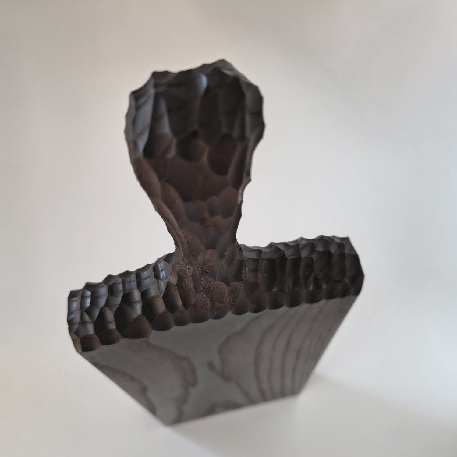 Black ash wooden serving board with sculpted L-shape and carved texture