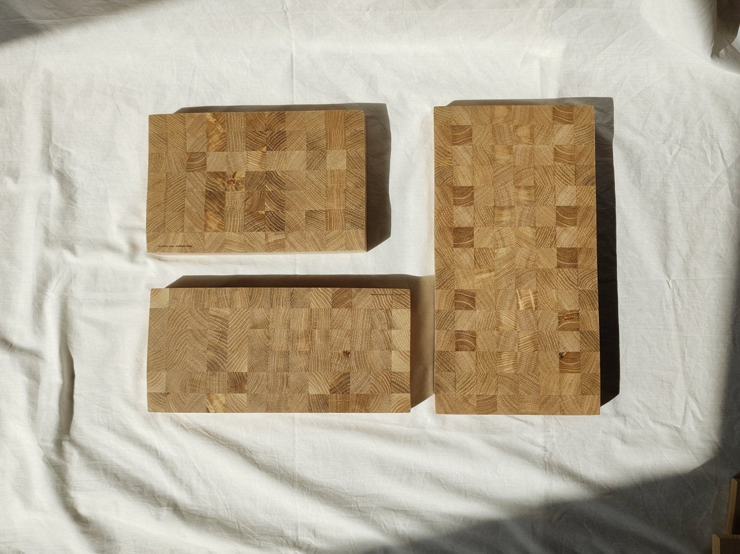 Set of wooden cutting boards with patchwork wood-grain pattern and rounded shapes