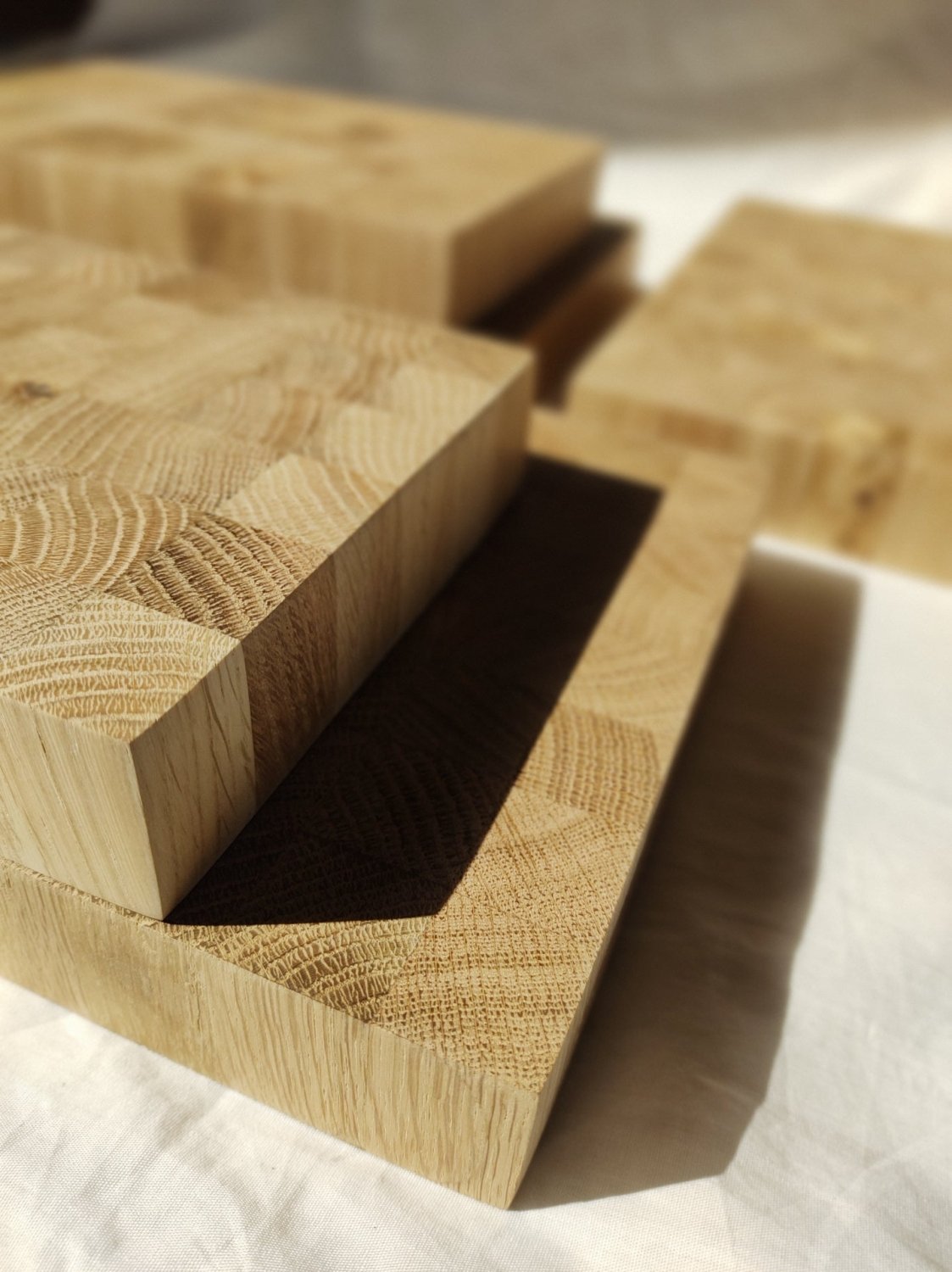 Wooden cutting board angled view showing thick frame and patchwork top