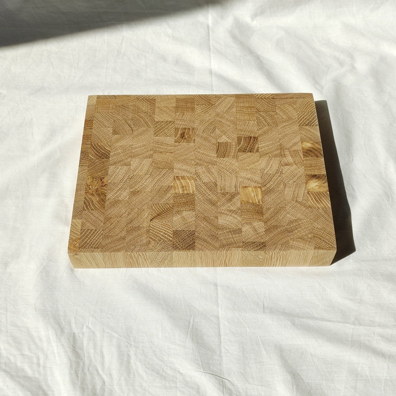 Wooden cutting board top with patchwork blocks and natural wood knots