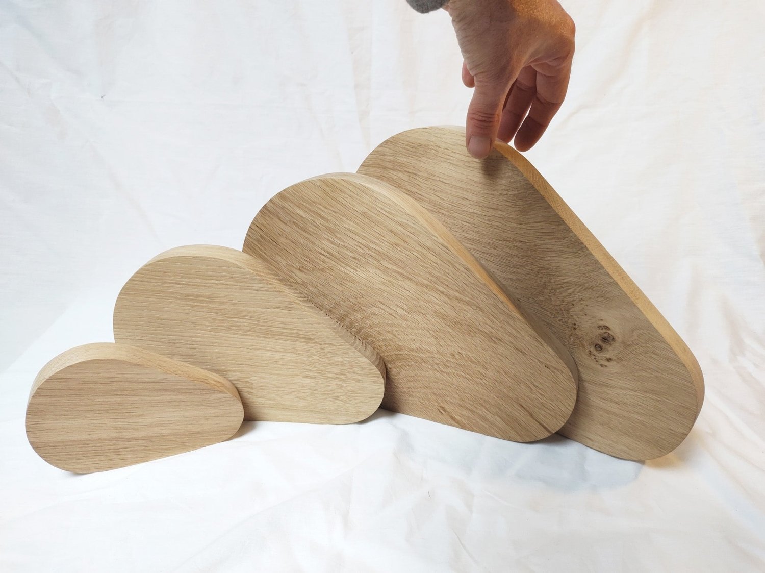 Pear-shaped wooden cutting boards set, hand holding one piece
