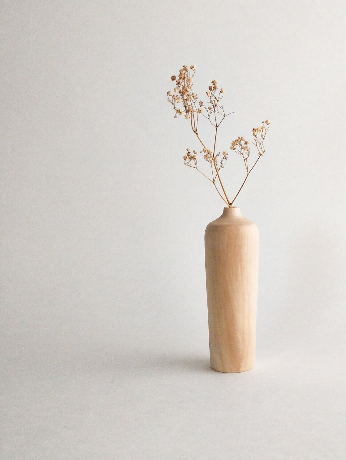 Maple wood mini vase with dried stems, tall light tan body with subtle vertical grain