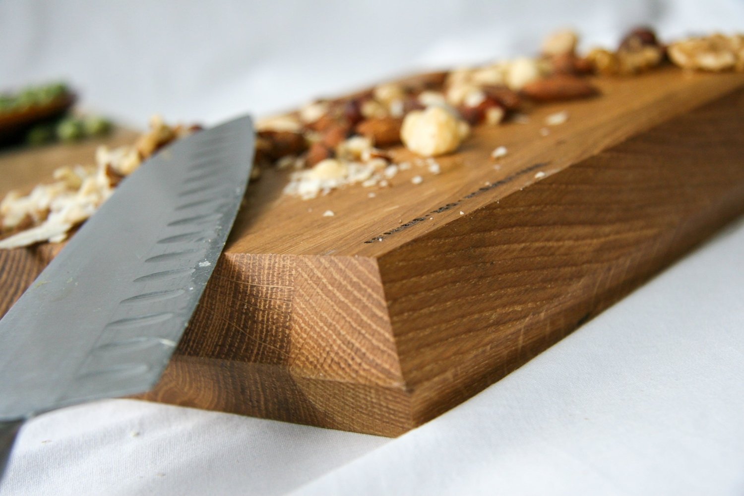 Wooden chopping board with a chef’s knife resting on the surface