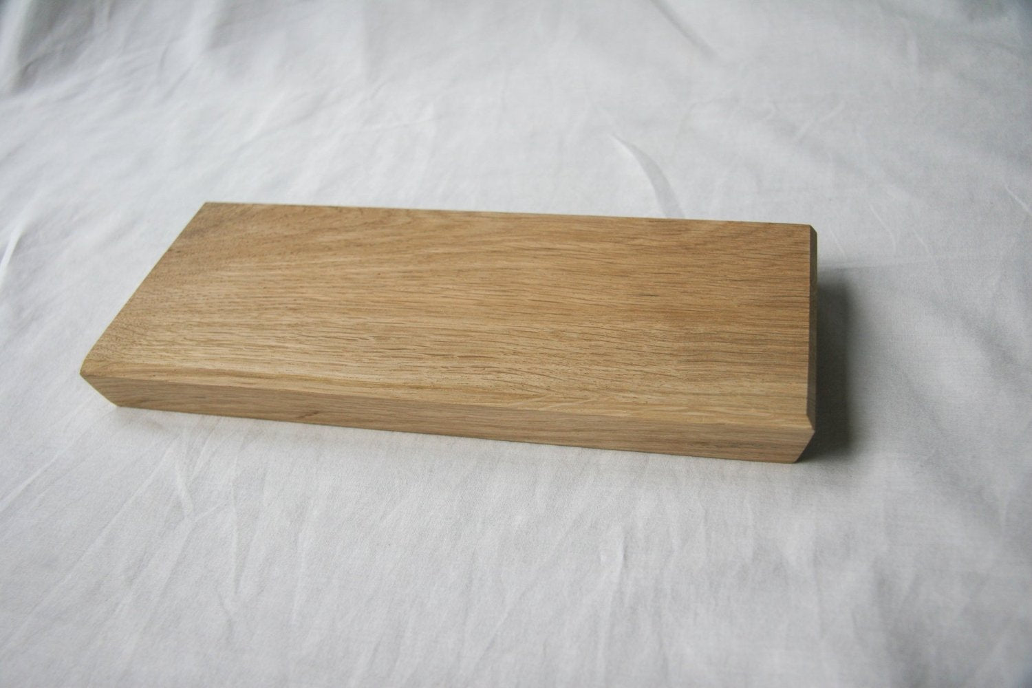 Rectangular wooden serving board with visible wood grain and beveled edges