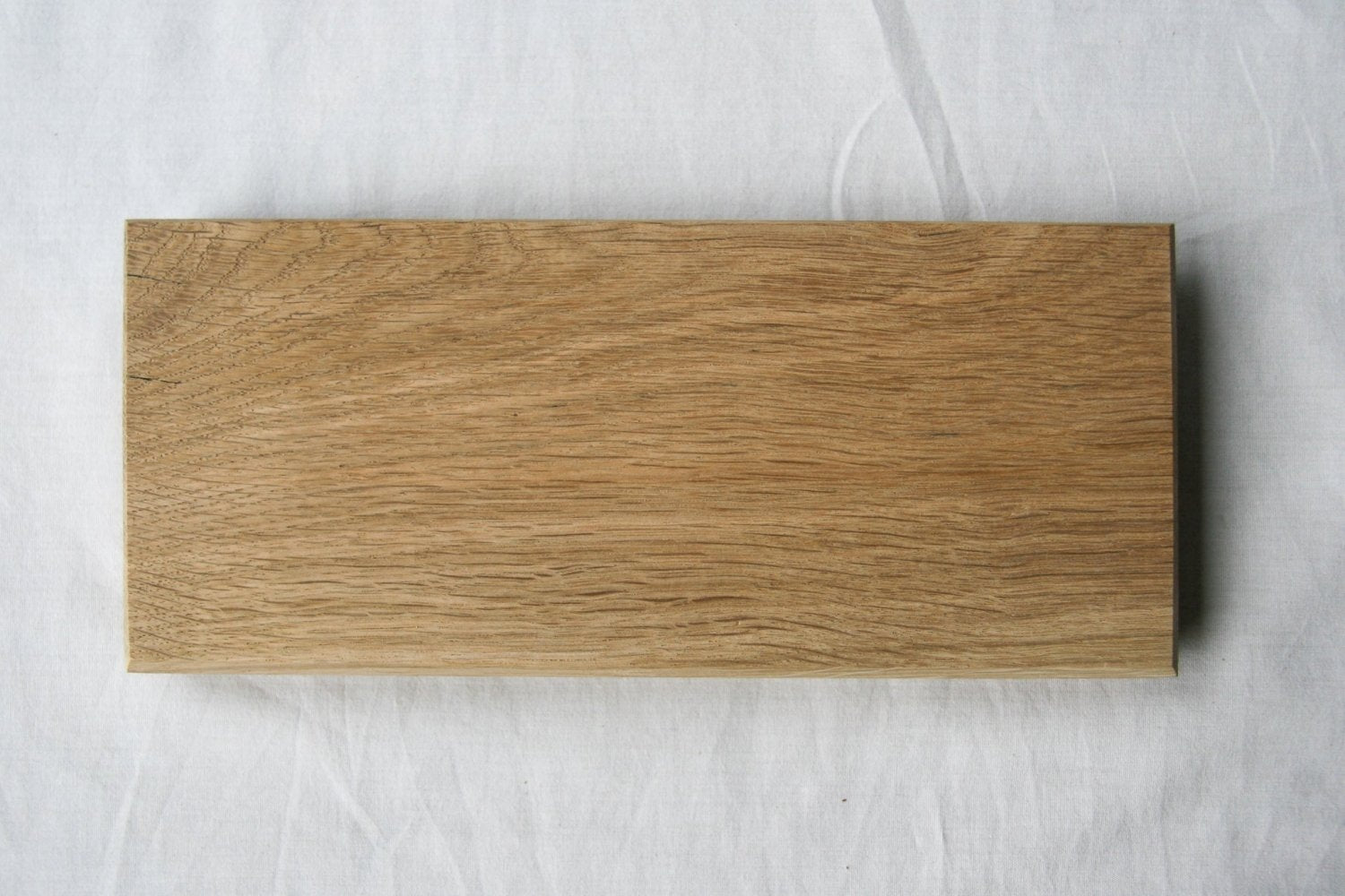 Large rectangular wooden serving board with smooth surface and wood-grain pattern