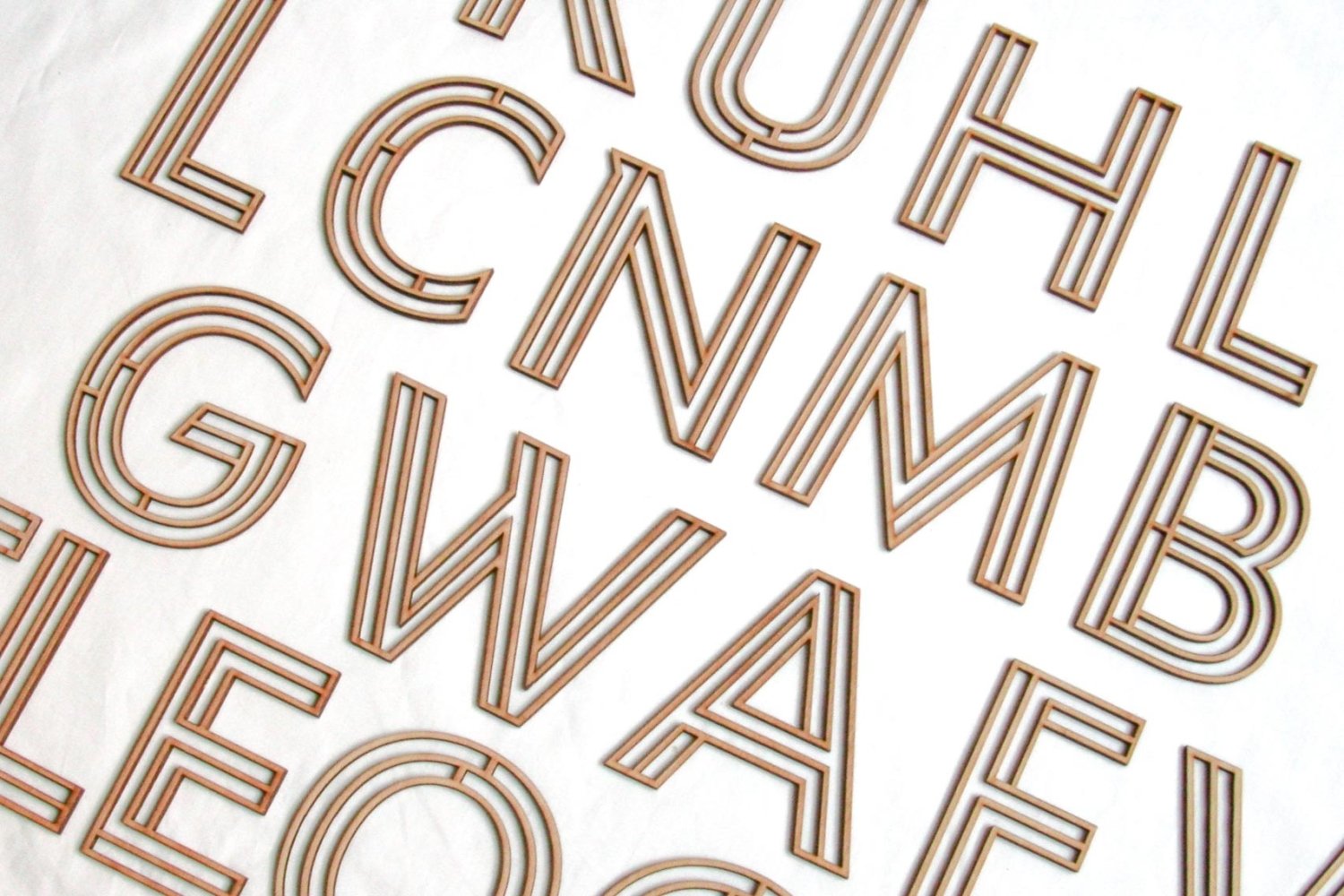 Wooden alphabet letters in tan and dark brown stacked outline style